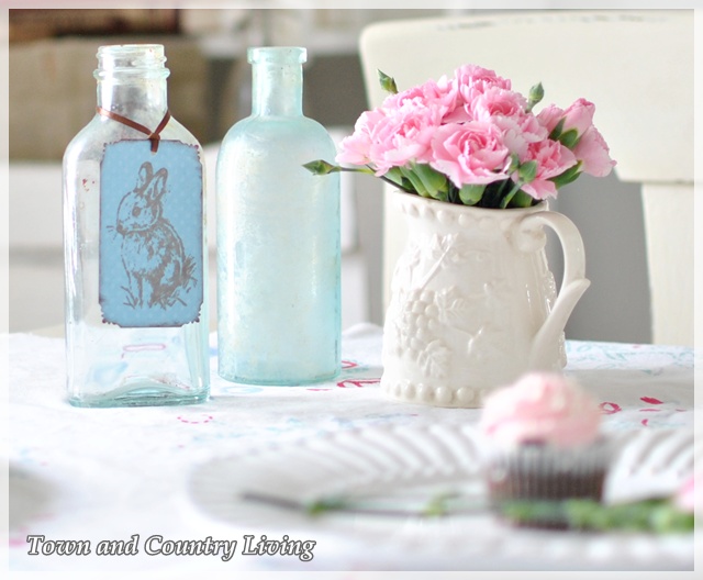 Pink carnations and aqua bottles