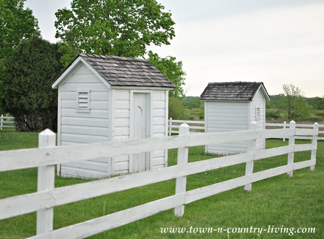 Shabby white outhouses at Pioneer Sholes School
