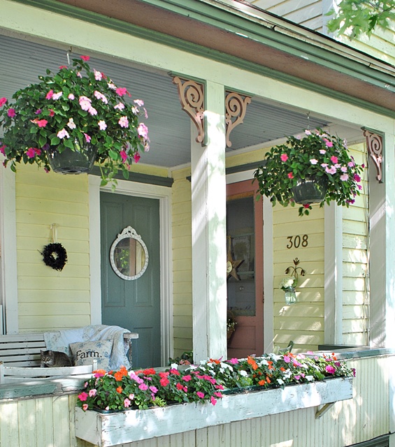 Hanging baskets on a summer farmhouse porch