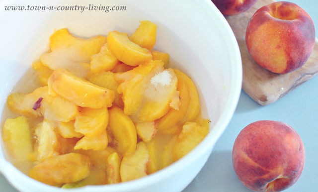 Peaches and sugar for simple peach cobbler - Town and Country Living