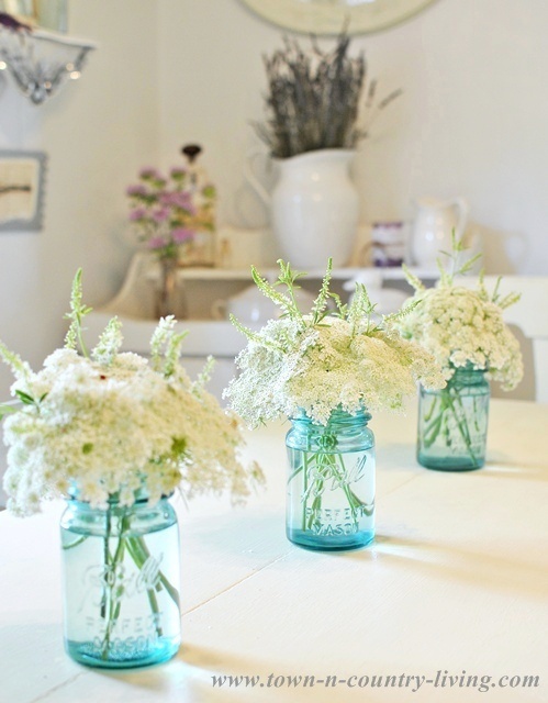 Wildflowers in Blue Mason Jars for Summer Decorating via Town and Country Living