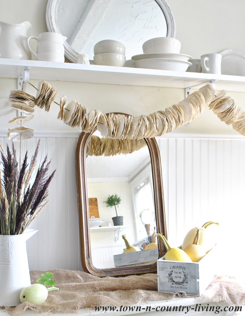 Vintage mirror and book page garland via Town and Country Living