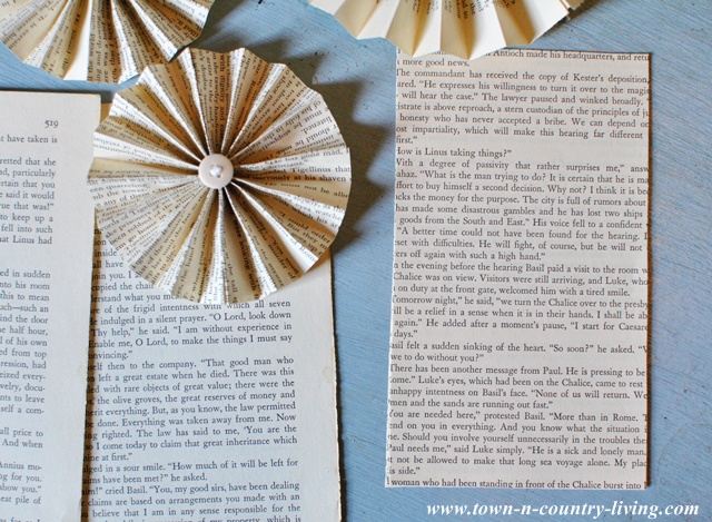 Materials to make a book page fan garland via Town and Country Living