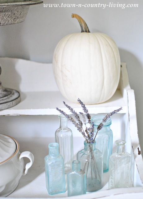Vintage Aqua Bottles and a White Pumpkin in a Dry Sink via Town and Country Living
