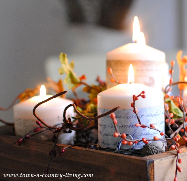 Candles create a fall centerpiece via Town and Country Living