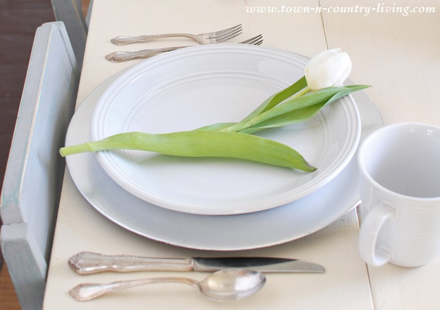 White tulip at a place setting via Town and Country Living