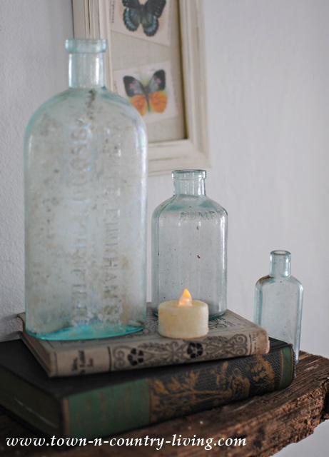 Vintage aqua bottles paired with vintage books