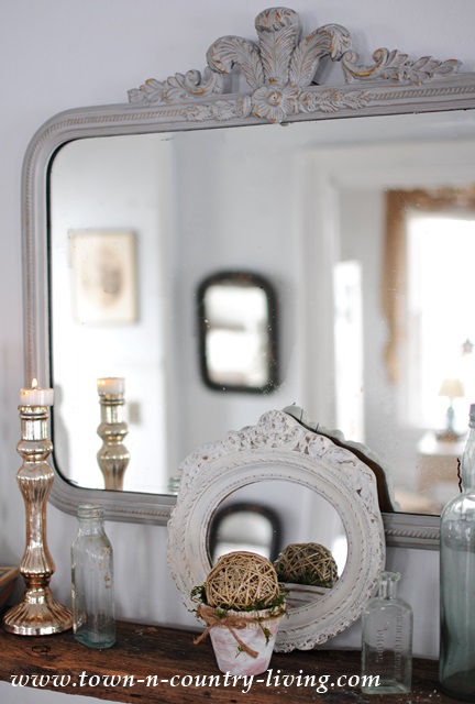 Mirror and glass vignette at Town and Country Living
