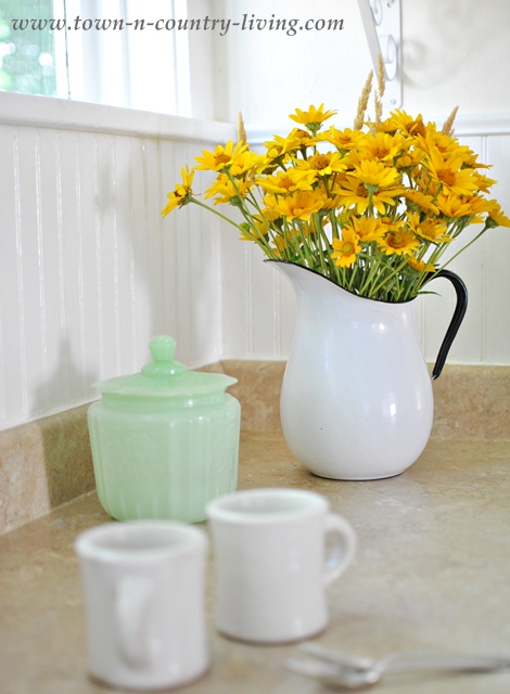 Yellow Wildflowers in a White Enamelware Pitcher