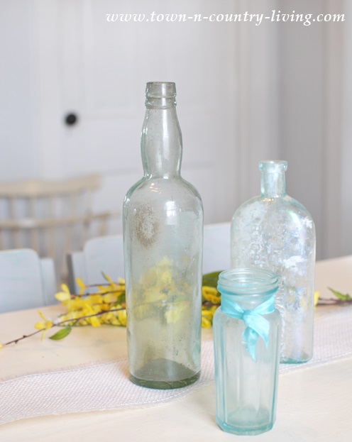 Vintage aqua bottles for a springtime centerpiece