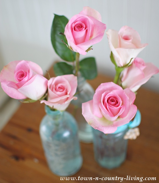 Springtime roses in vintage aqua vases