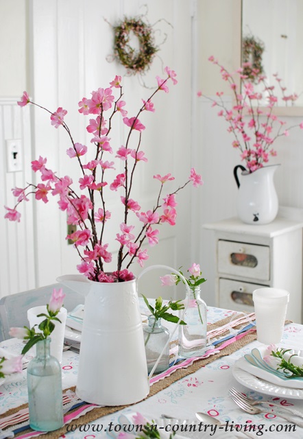 Spring blossoms in white enamelware pitchers