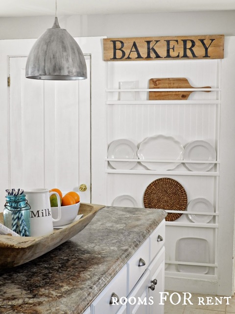 Plate rack wall in a cottage style kitchen