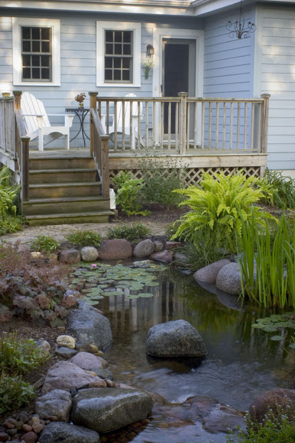 Outdoor living on a deck next to a water garden
