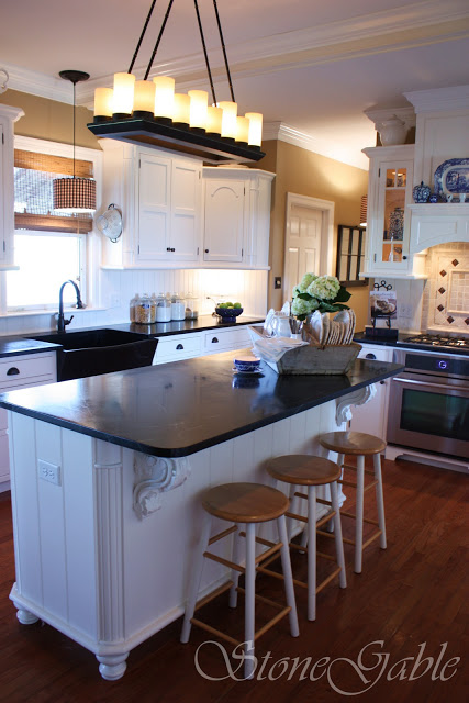 Black countertops and white cabinets in a traditional style kitchen