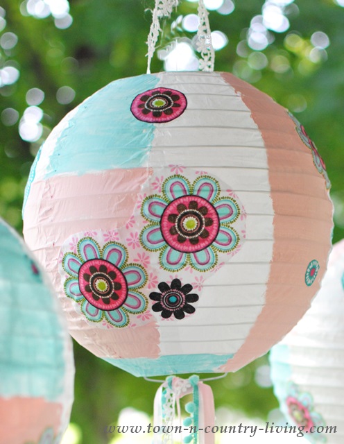 Paper lantern painted and decoupaged with pretty fabric.