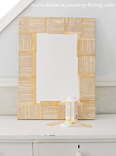 Book pages glued to canvas to create faux frame