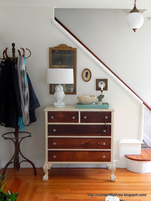 Vintage dresser in entry way creates storage for keys, mail, and more