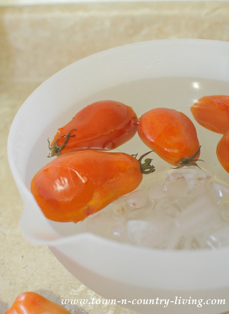 Giving tomatoes an ice bath after briefly boiling them to make them easier to peel