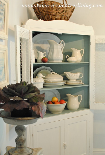 Farmhouse hutch filled with white ironstone