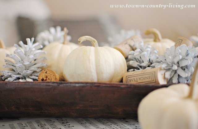Painted Pine Cones, Baby Boos, and Wine Corks displayed in a Wooden Dough Bowl