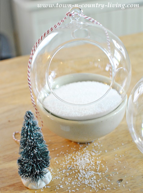 Use kosher or epsom salt to create faux snow in a hanging snow globe.