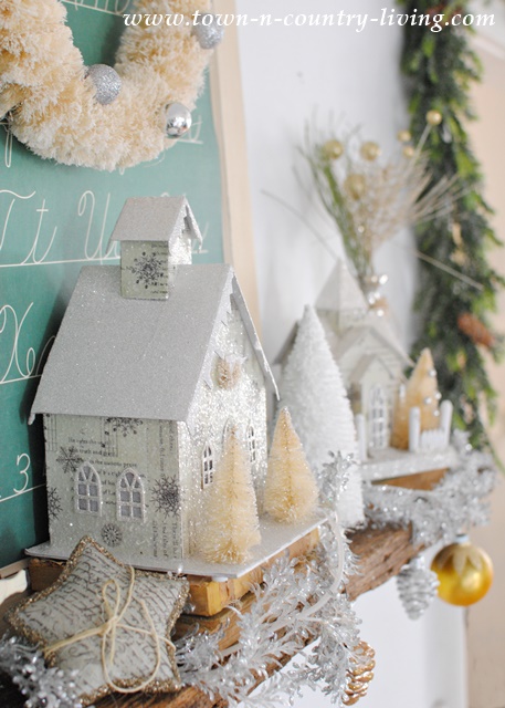 DIY Home Decor for Christmas. Glitter houses and bottle brush trees create a festive mantel.