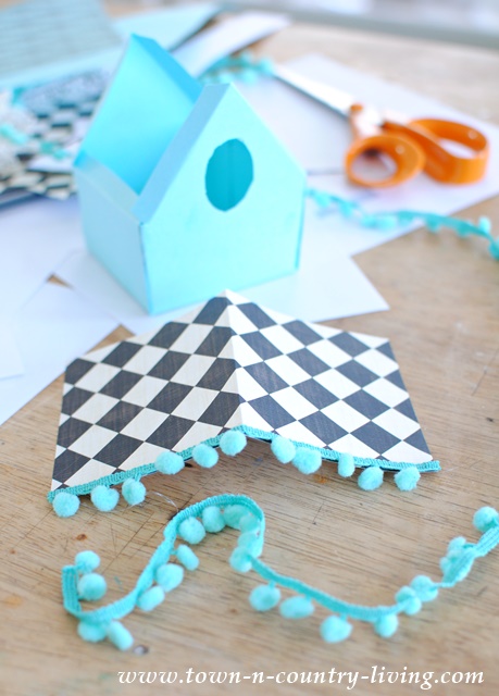 How to make paper birdhouses using scrapbook paper and decorative trim.