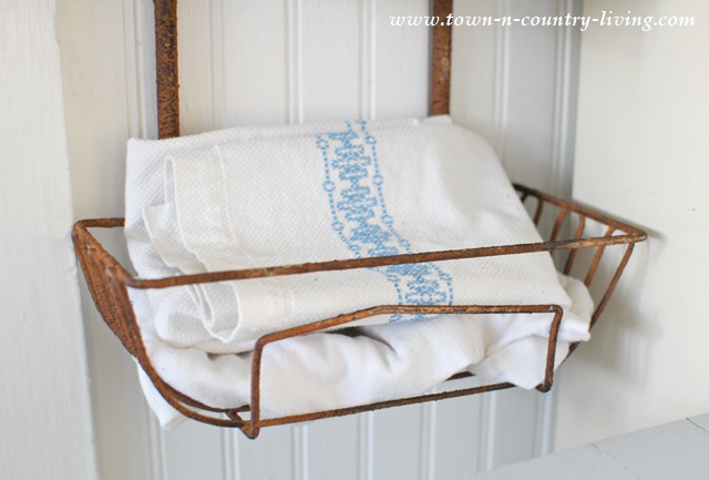 Vintage kitchen towels in wall basket hanger
