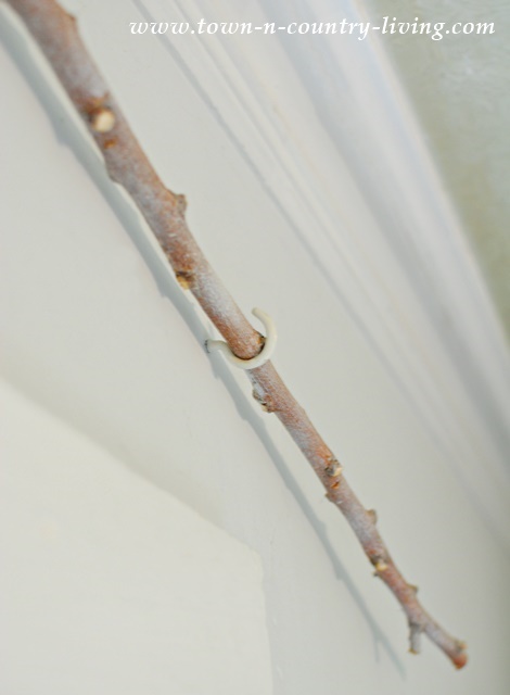 Tree branch used as curtain rod, mounted with simple hooks.